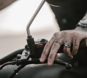 Person holding black metal tool 4348226 360x320