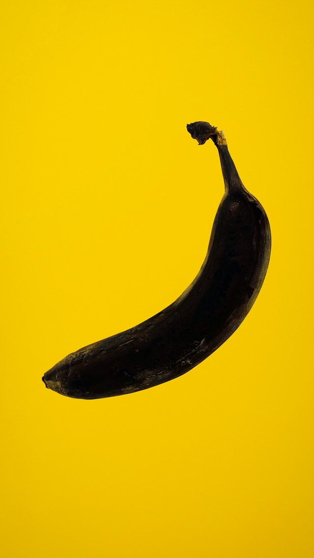 Rotten banana on yellow background 3600078