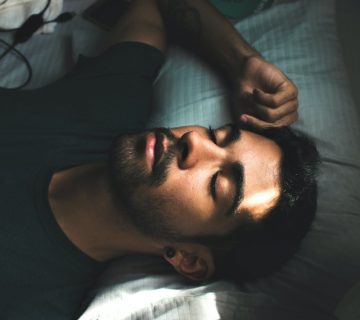 Man in crew neck t shirt lying on bed 3981599 360x320