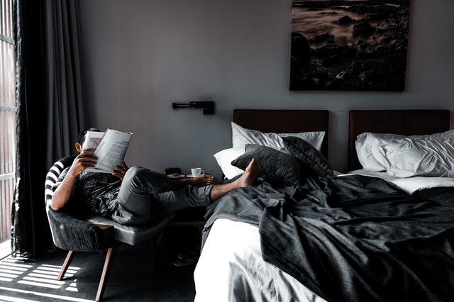 Man sitting on chair reading book 4070924