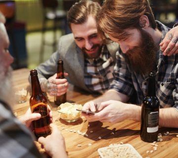 Man using his phone at a bar 3851464 360x320
