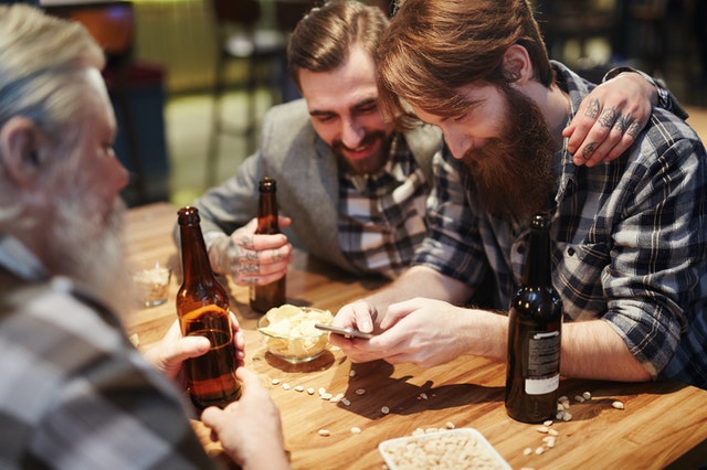 Man using his phone at a bar 3851464