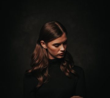 Photo of woman in black turtleneck sweater posing in front 3199036 360x320