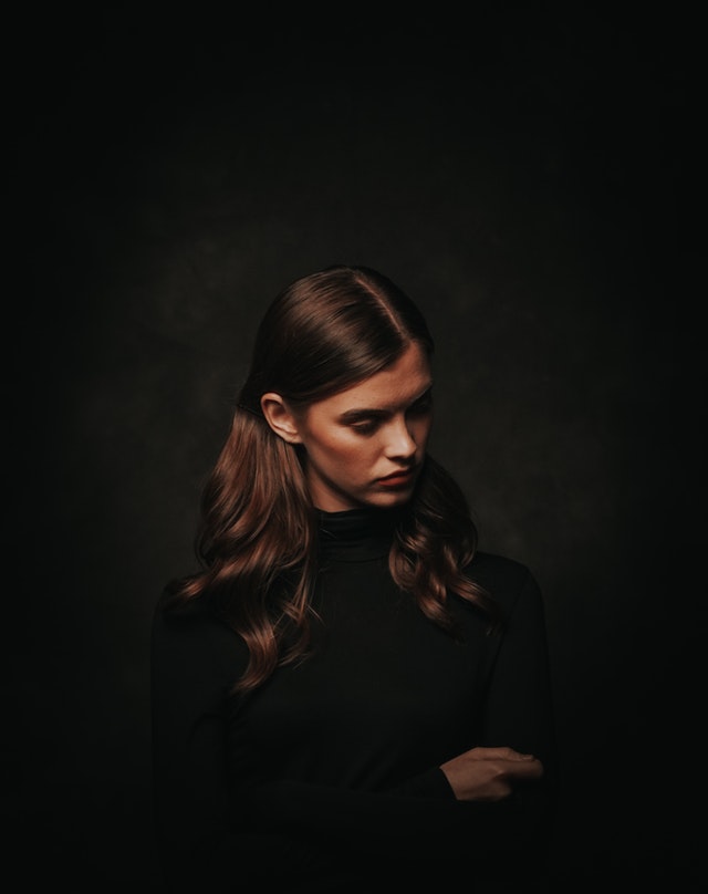 Photo of woman in black turtleneck sweater posing in front 3199036