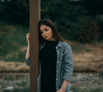 Woman standing beside brown wooden post 3151787 360x320