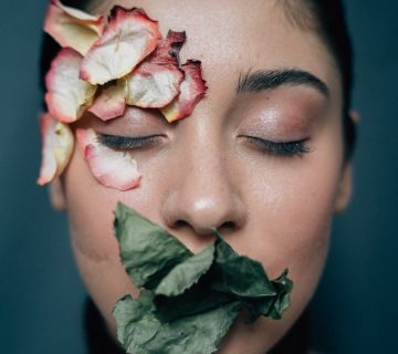Woman with white rose on her mouth 4850291 360x320